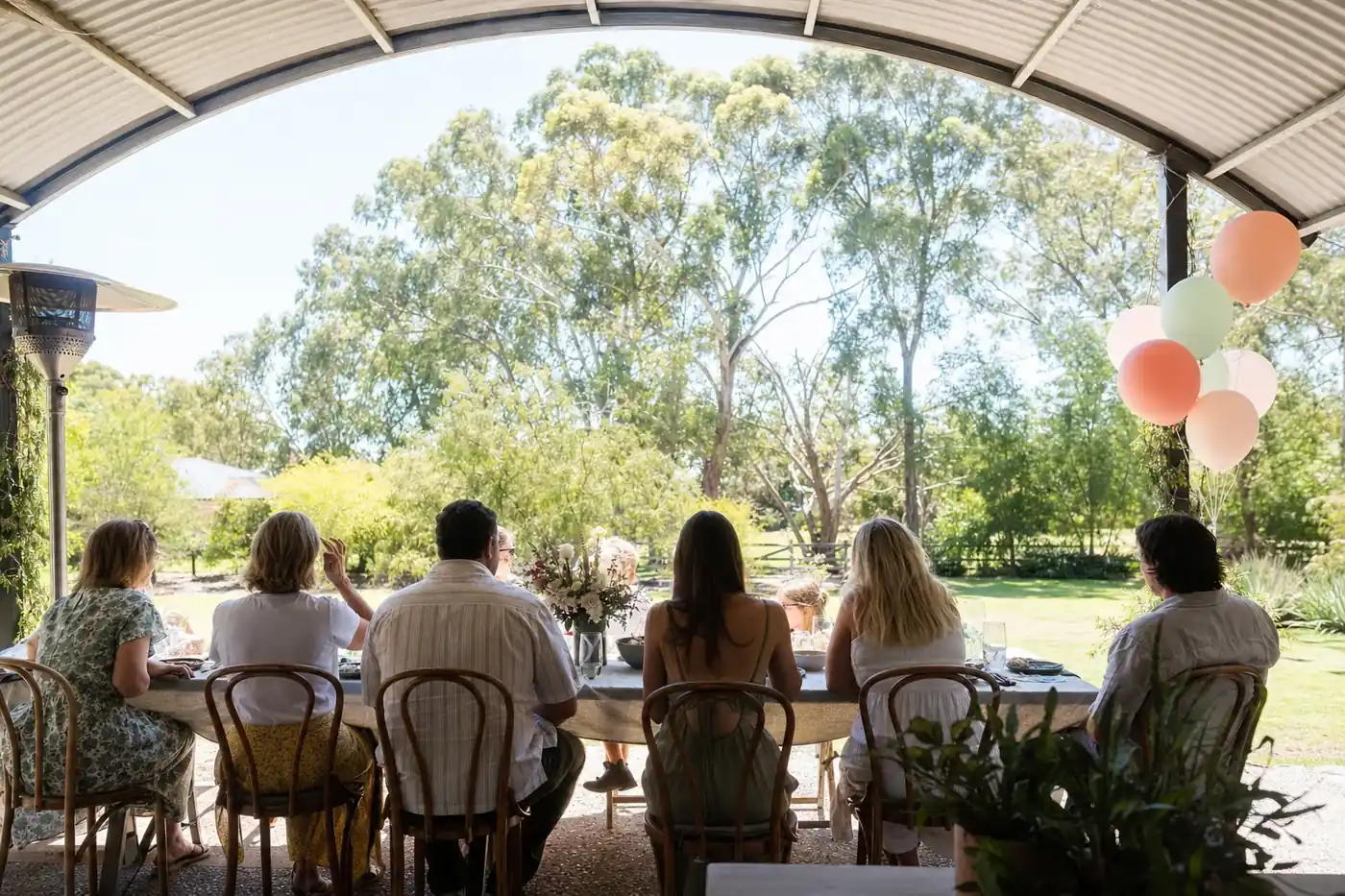 Birthday lunch at a long table under a curved dome patio in a Perth backyard
