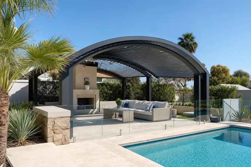 Charcoal dome patio with a curved roof over an outdoor lounge beside a Perth backyard pool