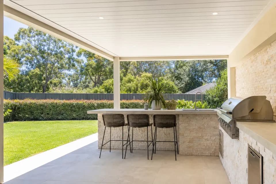 Insulated patio over an outdoor kitchen and dining area on a Perth home