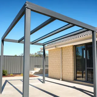 Steel patio frame being installed beside a brick home
