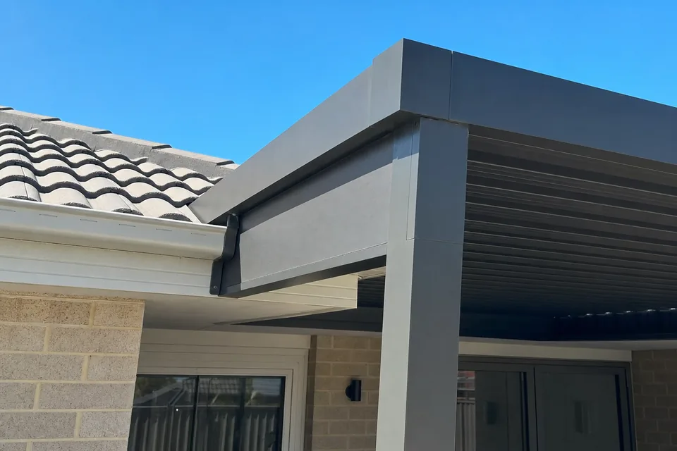 Back beam of a raised flat patio on brackets just above the gutter of a grey tiled Perth roof